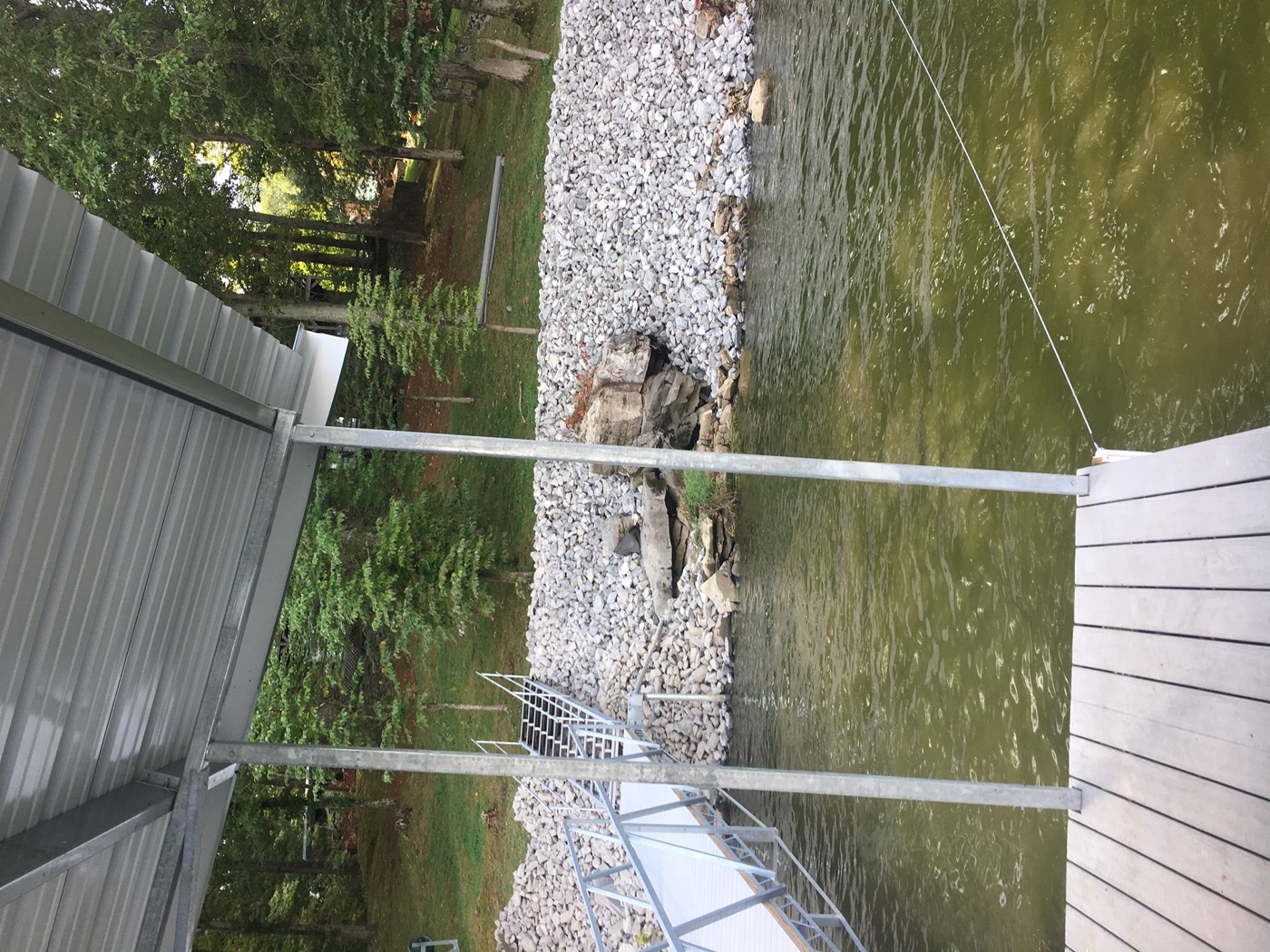 Riprap shoreline with a Twin Lakes aluminum gangway and steps leading up from the dock